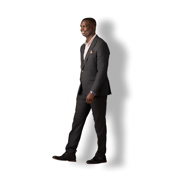 Dr Solomon Kpandei walking, in a dark suit
